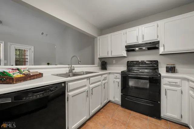 a kitchen with a sink stove and cabinets