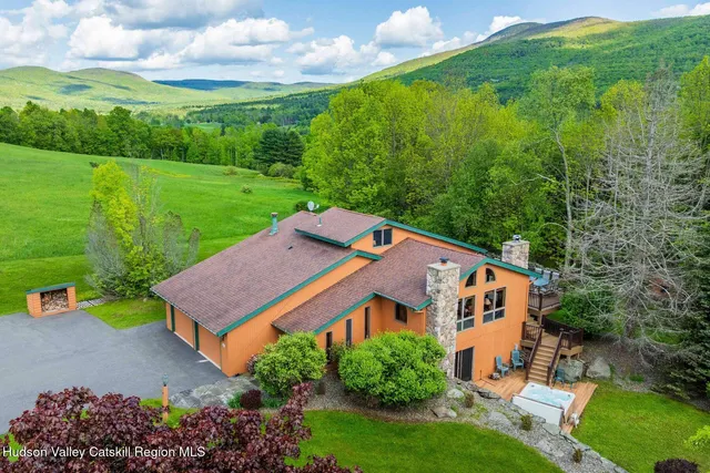 an aerial view of a house with a yard