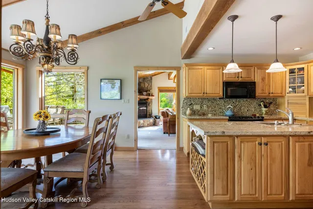 a kitchen with stainless steel appliances granite countertop a sink a stove and a wooden cabinets