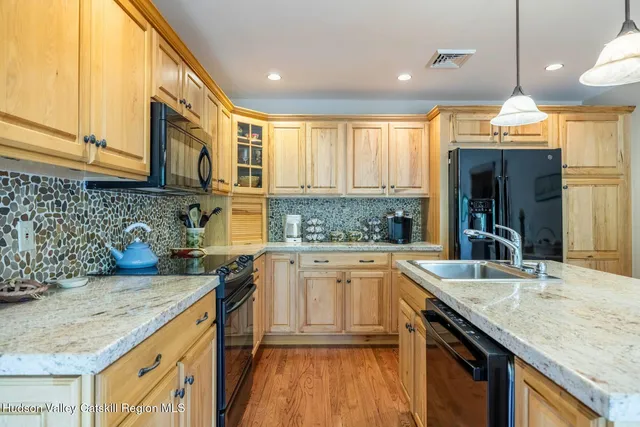 a dining room with furniture a chandelier and wooden floor