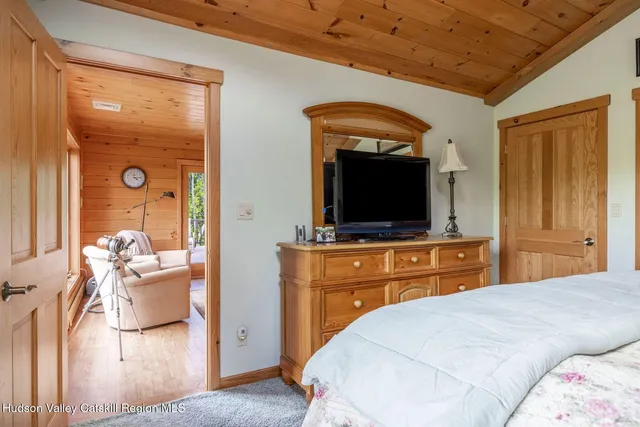 a bedroom with a bed next to a window