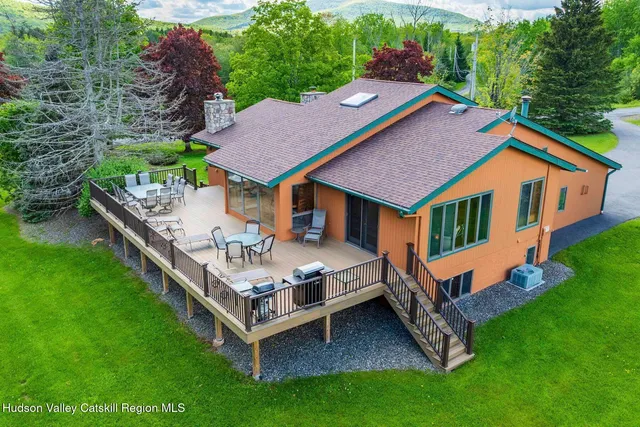 a aerial view of a house with a yard table and chairs