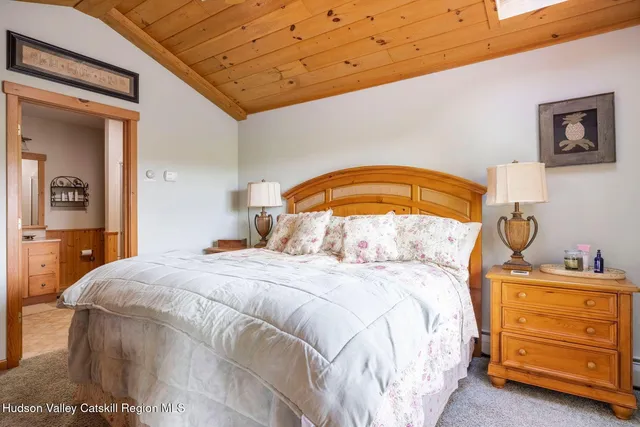 a living room with furniture a wooden floor and a large window