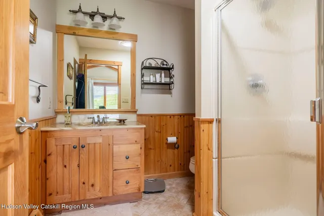 a living room with a fireplace a rug and a window