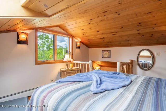 a bedroom with a large bed and a large window