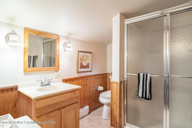 a view of a patio with dining table and chairs with wooden floor and fence