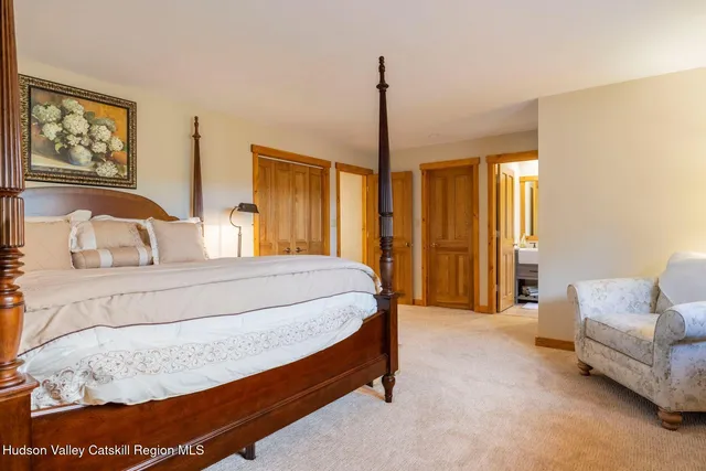 a view of a big yard with potted plants and large trees