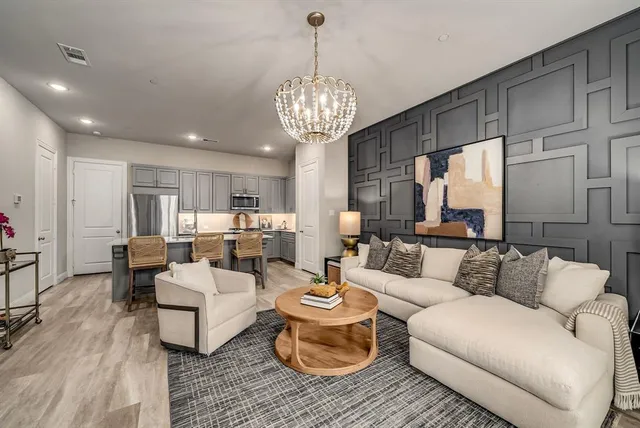 a living room with furniture and a chandelier