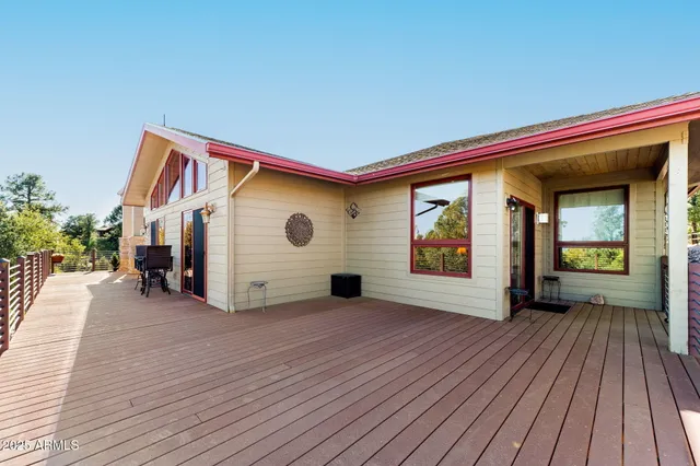 a view of an outdoor space with wooden floor and a window