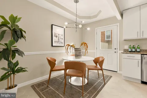 a dining room with furniture and a chandelier