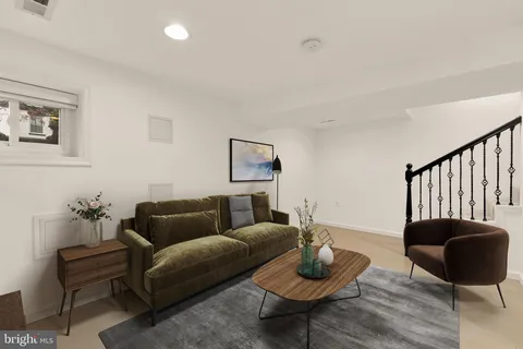 a living room with furniture and a rug