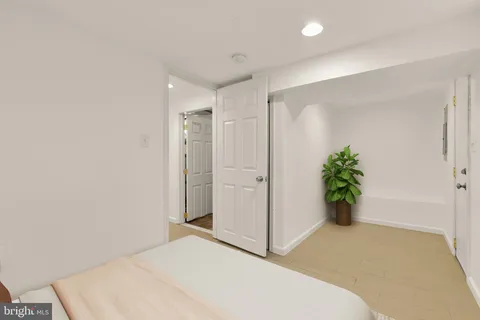 a bedroom with a bed and a potted plant