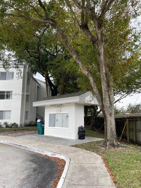 5612 Rock Island Road, Unit 167 Tamarac, FL 33319 - Photo 15 of 16 a front view of a house with a yard and garage