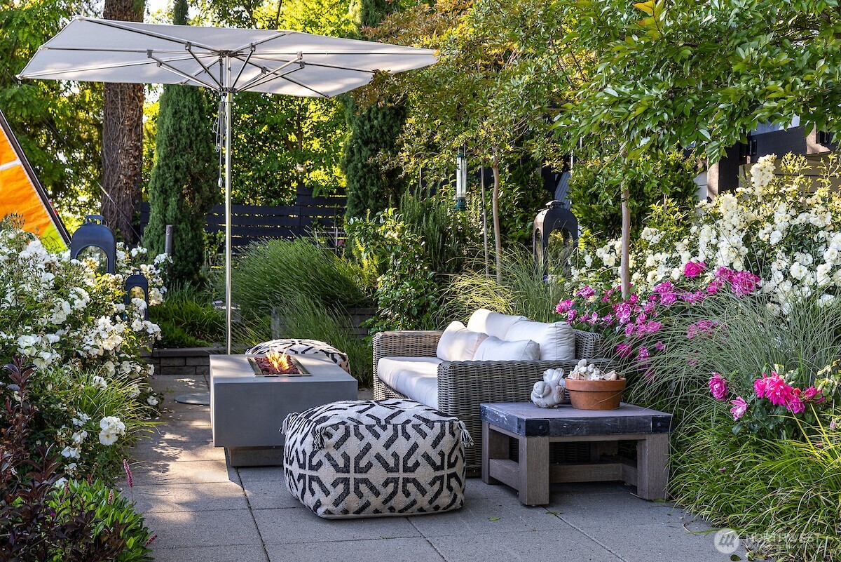 8097 West Mercer Way Mercer Island, WA 98040 - Photo 34 of 40 a view of a patio with a table and chairs under an umbrella