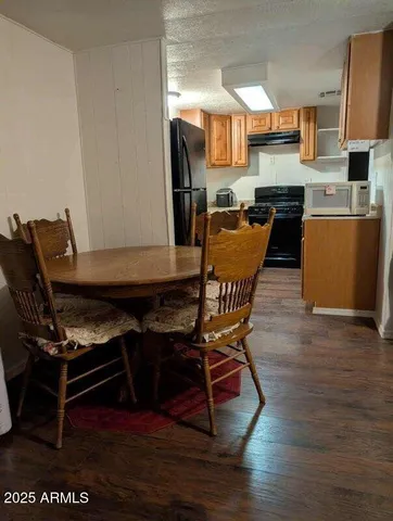 a kitchen with granite countertop a stove a sink and a refrigerator