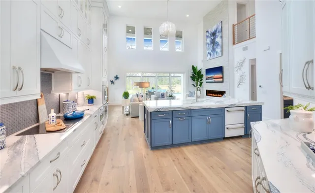 a kitchen with stainless steel appliances granite countertop a table chairs sink and cabinets