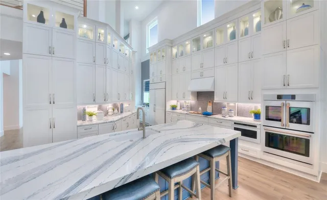 a living room with stainless steel appliances kitchen island granite countertop furniture and a kitchen view