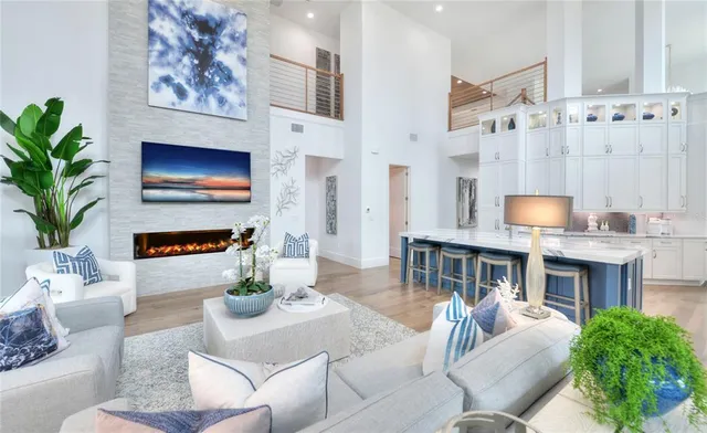 a living room with furniture fireplace and a large window