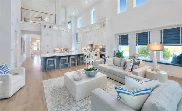a view of a living room with furniture and a large window