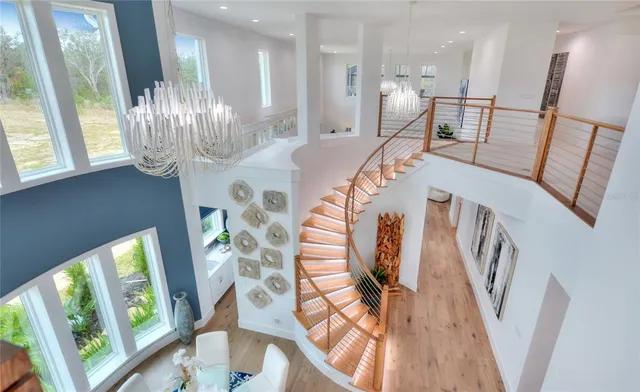 a spacious bedroom with a bed and a chandelier