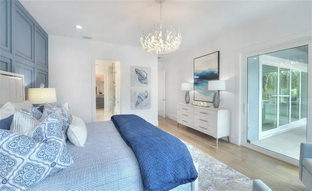 a bedroom with a bed and a chandelier