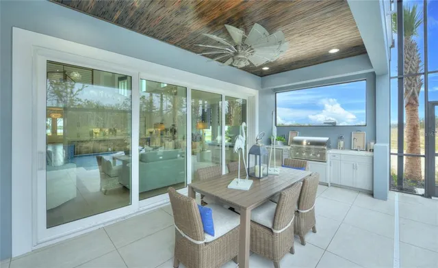 a view of a dining room with furniture a chandelier and wooden floor