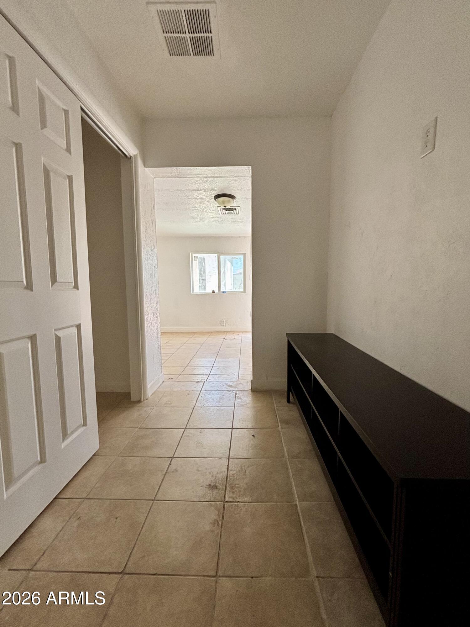 3036 West Almeria Road Phoenix, AZ 85009 - Photo 8 of 20 a view of an empty room with a window