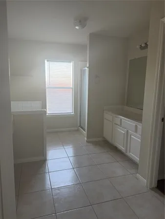 a bathroom with a bathtub and shower