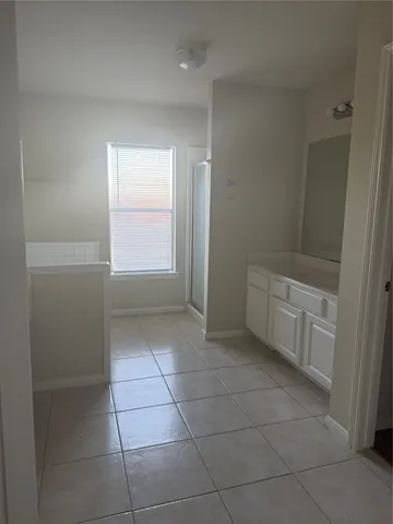a bathroom with a bathtub and shower