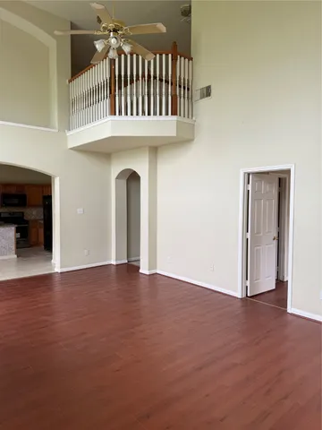 a kitchen with granite countertop a refrigerator and a stove top oven