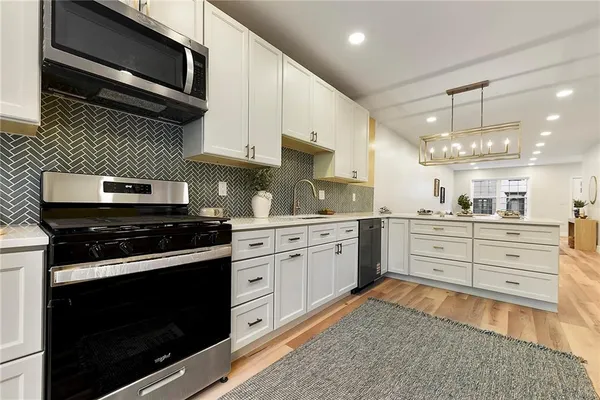 a kitchen with a stove microwave and cabinets