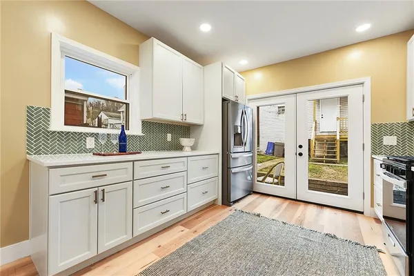 a spacious bathroom with a granite countertop sink mirror and