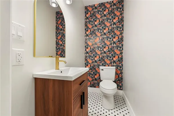 a bathroom with a sink a toilet and a mirror