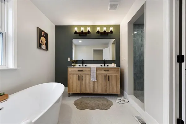 a bathroom with a sink a mirror and a bathtub