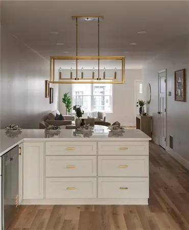 a kitchen with cabinets appliances and a large window