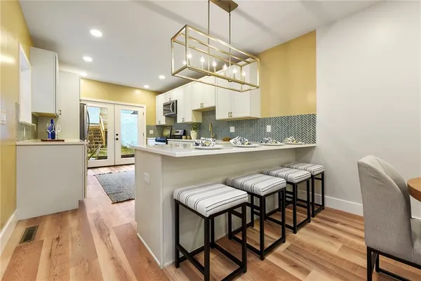 a kitchen with stainless steel appliances kitchen island granite countertop a sink and cabinets