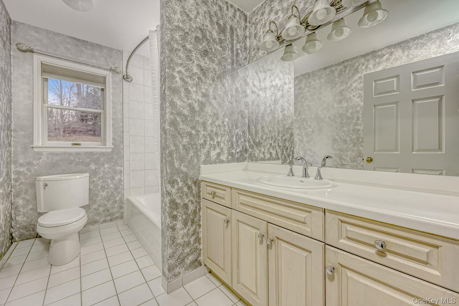 22 Golden Road Suffern, NY 10901 - Photo 26 of 41 Full bath with vanity, light tile patterned floors, and shower / bath combo with shower curtain