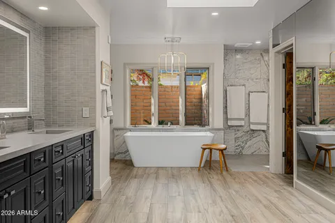 a bathroom with double sink and a mirror