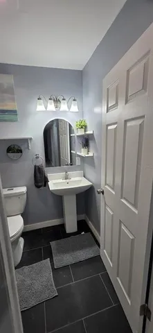 a bathroom with a toilet a sink and bathtub