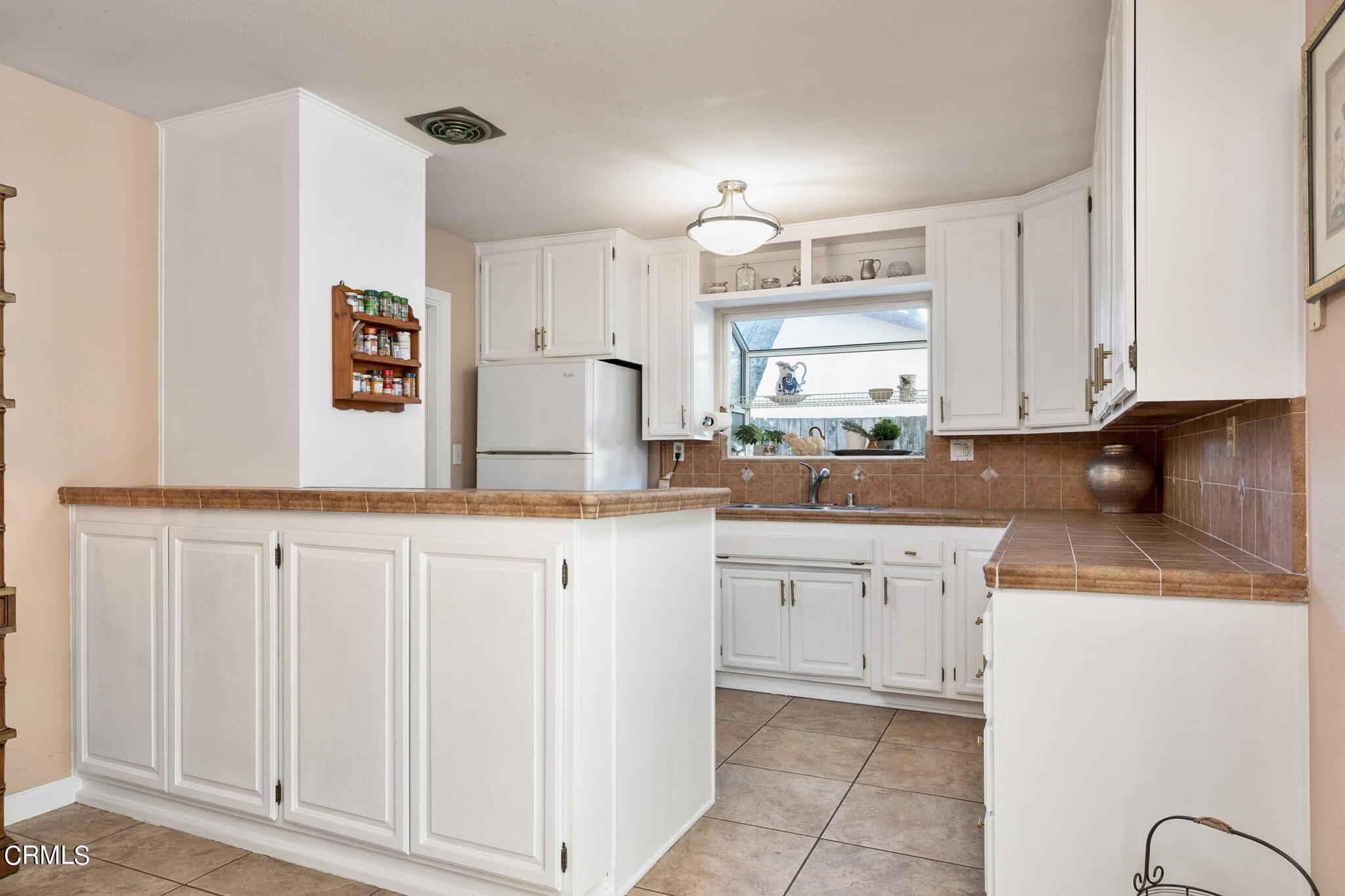1039 South Rice Road Ojai, CA 93023 - Photo 22 of 50 a kitchen with granite countertop white cabinets white appliances and sink