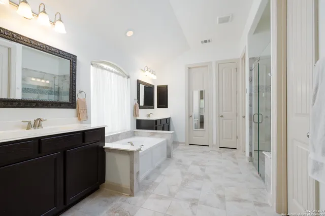 a view of a bathroom with a sink mirror and a bathtub