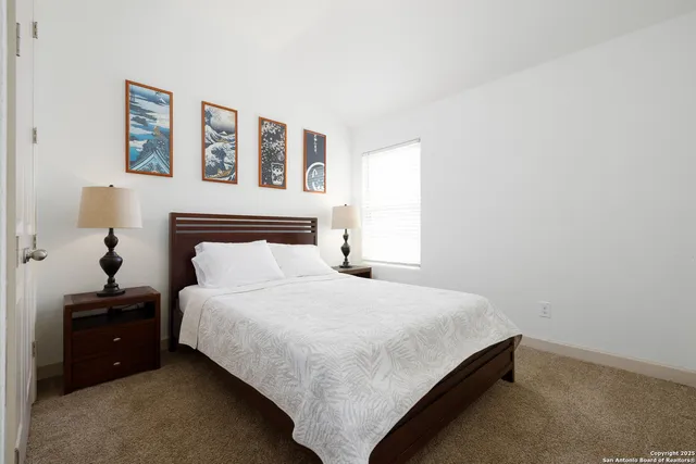 a bedroom with a bed and a night stand