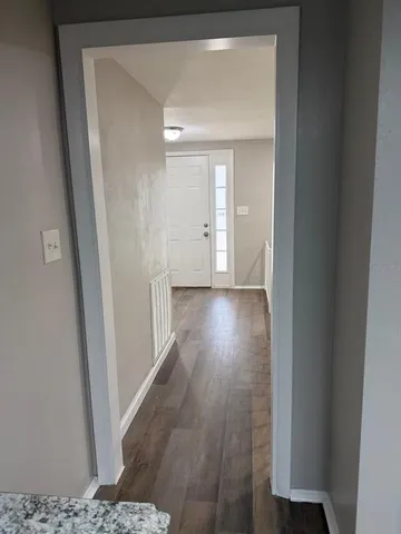 a kitchen with granite countertop wood cabinets and a stove