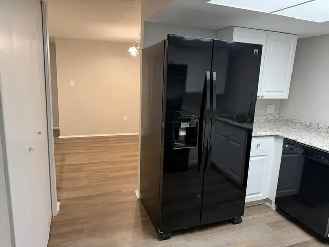 a kitchen with a sink and a refrigerator