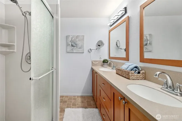a bathroom with a granite countertop sink a toilet and shower