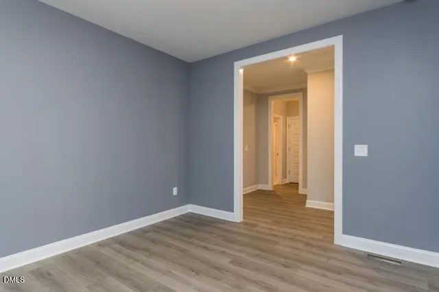 a view of an empty room with a window and fireplace