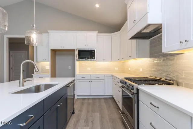 a bathroom with a shower sink and mirror