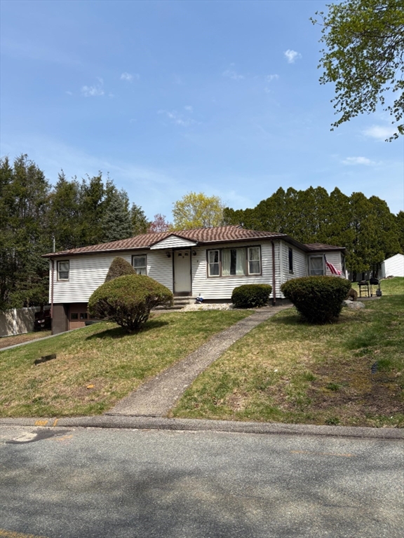8 Tanyard Road Dudley, MA 01571 - Photo 1 of 16 a front view of a house with a yard