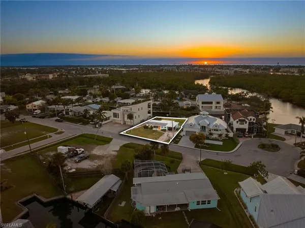 an aerial view of a house with a ocean view