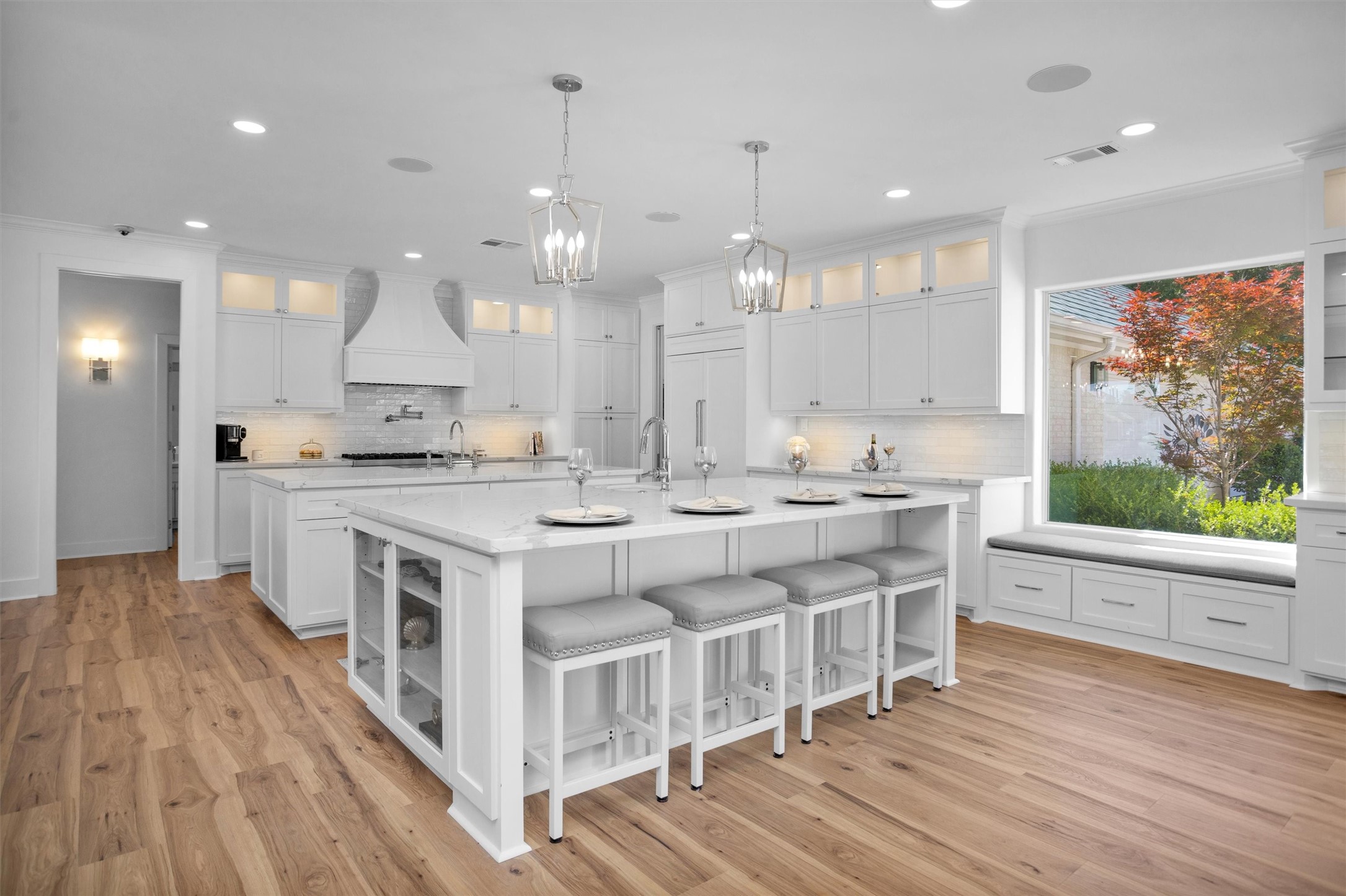 16059 Walden Road Conroe, TX 77356 - Photo 11 of 50 a large white kitchen with kitchen island wooden floors and stainless steel appliances